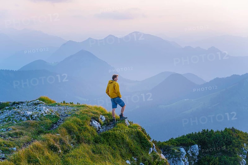Hikers at the summit of the Benediktenwand at sunset