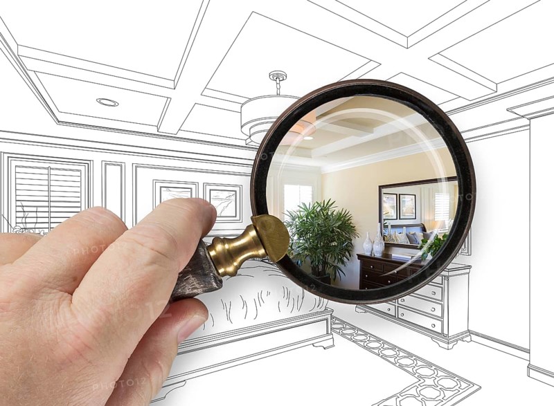 Hand holding magnifying glass revealing custom bedroom design drawing and photo combination