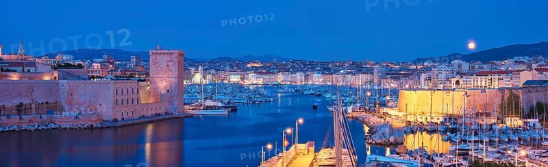 Panorama of Marseille Old Port and Fort Saint-Jean illumintaed in night with moon