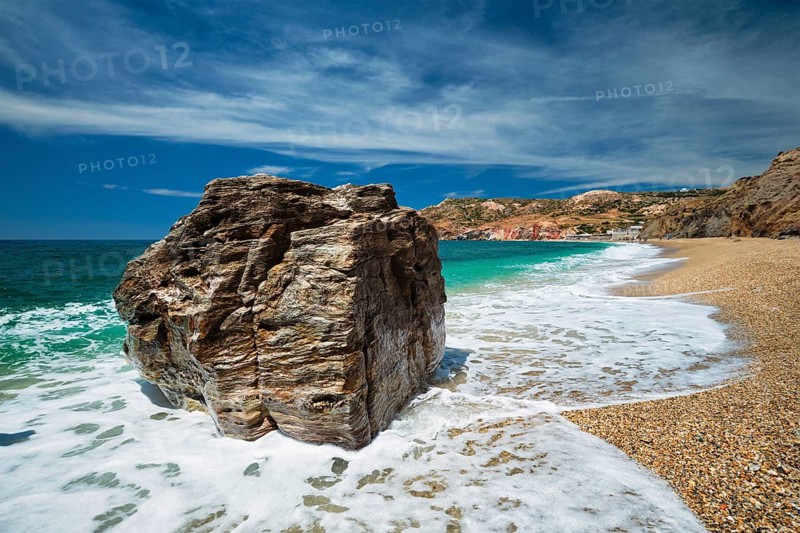 Rocks on Paleochori beach and waves of Aegean sea