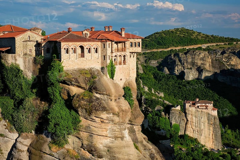 Monastery of Varlaam monastery and Monastery of Rousanou in famous greek tourist destination Meteora in Greece on sunset with scenic scenery landscape