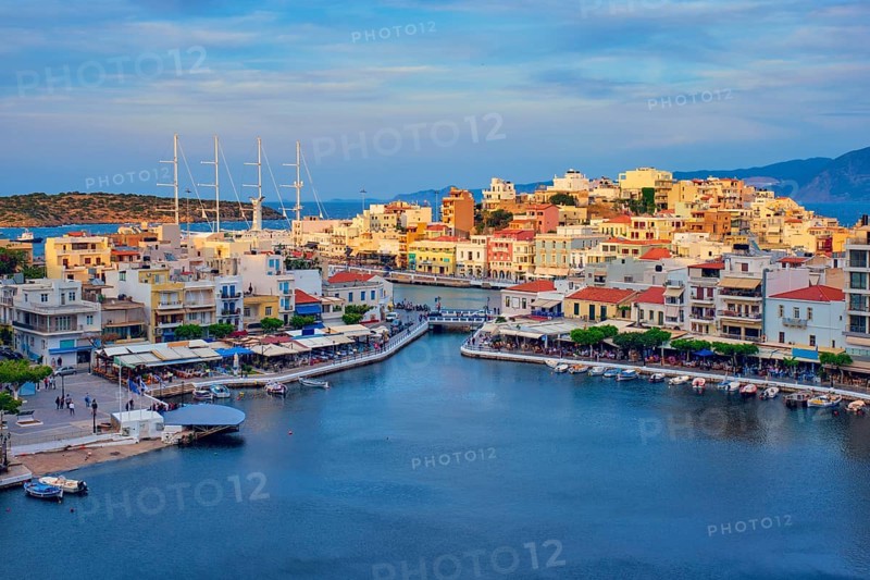 Beautiful Agios Nikolaos town on lake Voulismeni on sunset. Lasithi region of Crete island