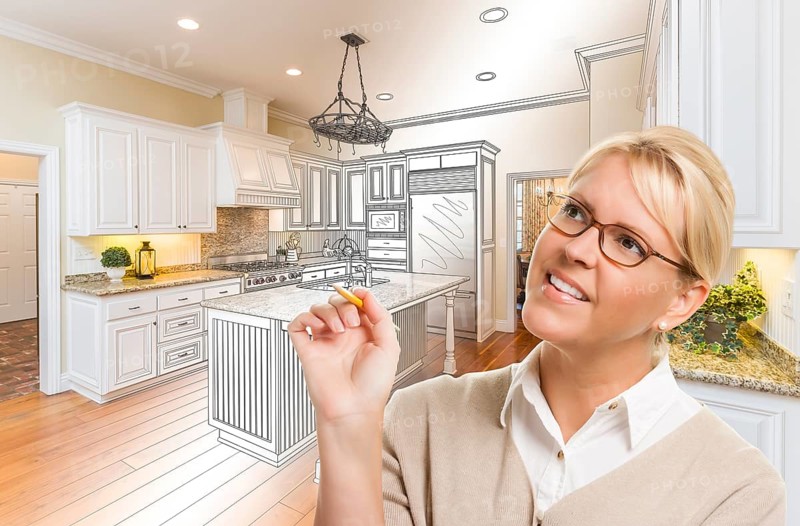 Creative woman with pencil over custom kitchen design drawing and photo combination