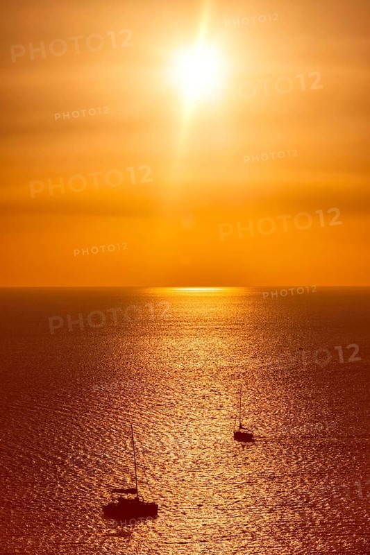 Yacht boats silhouettes in Aegean sea on sunset. Mykonos