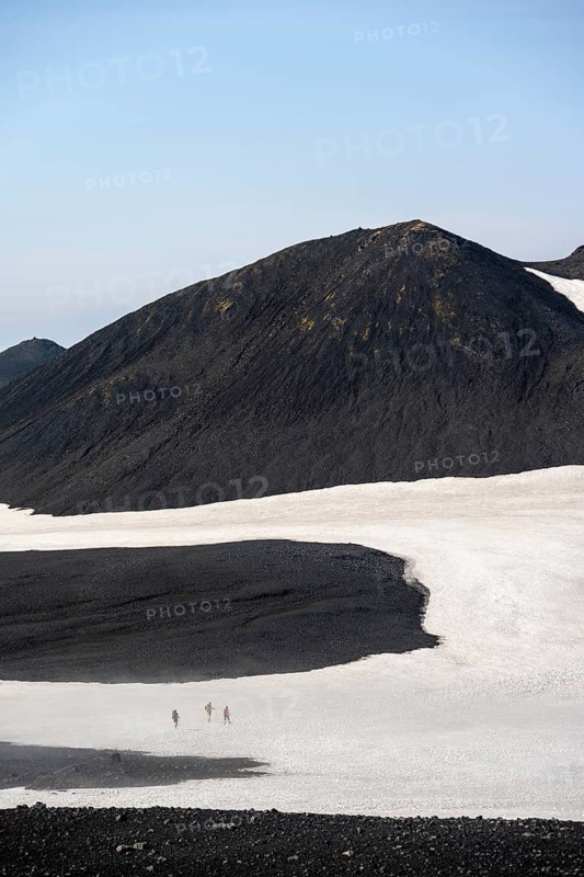 Hikers in the distance on a snow field