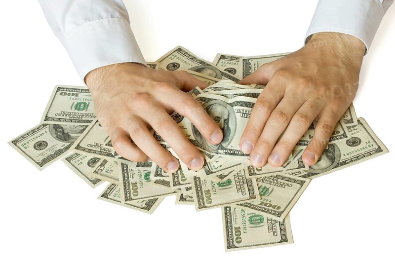 Greedy hands grabbing money lot of dollars