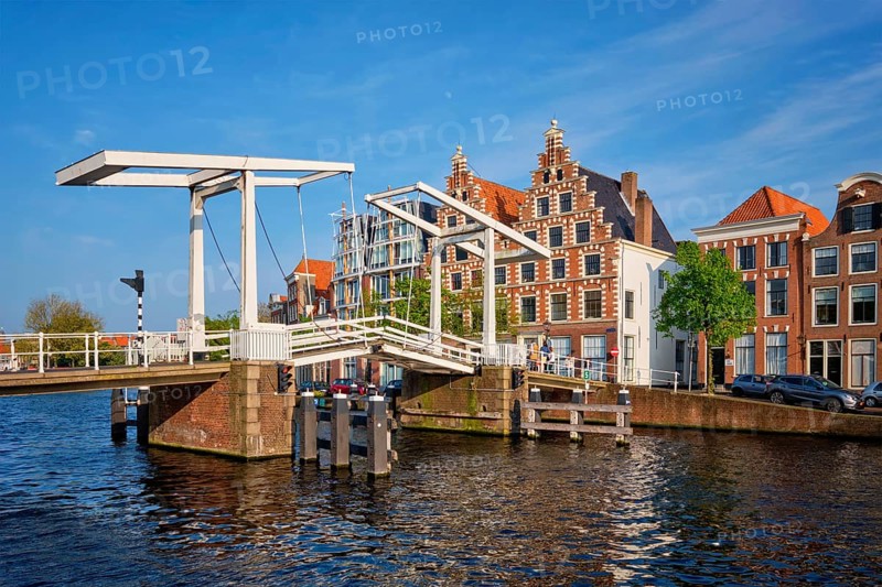 Gravestenenbrug bridge on Spaarne river and old houses in Haarlem