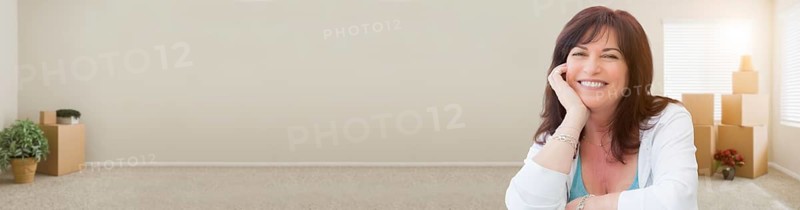 Banner of middle aged woman relaxing inside empty room with moving boxes