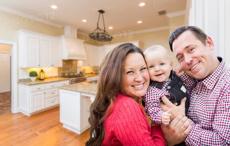Young happy family inside beautiful custom kitchen