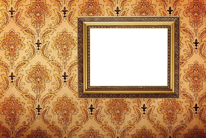 Vintage gold plated picture frame on retro wallpaper background