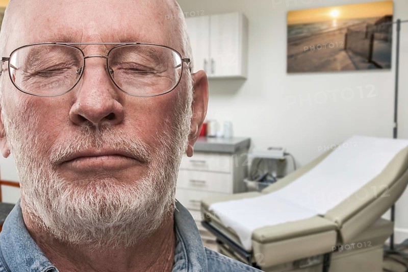 Worried senior adult man waiting in doctor office