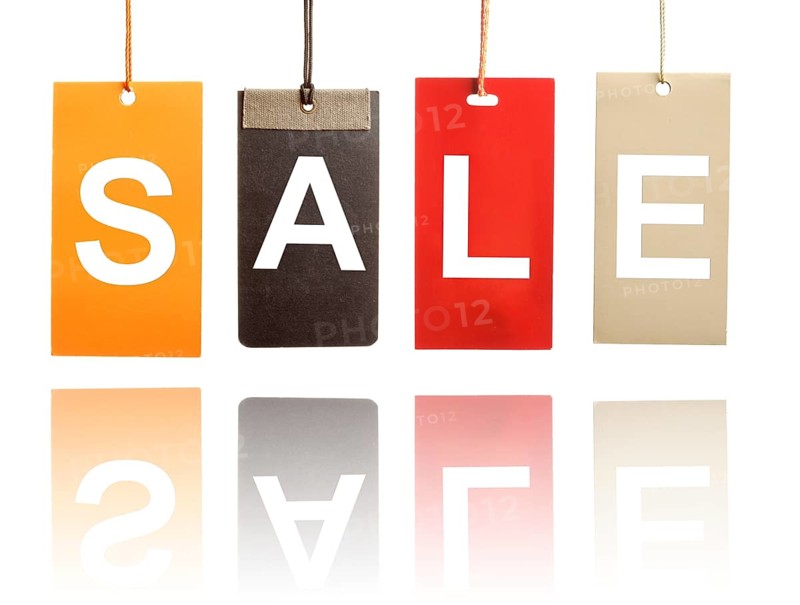 Sale written on paper tags isolated on white background