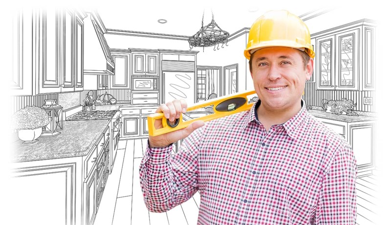 Smiling contractor in hard hat with level over custom kitchen drawing