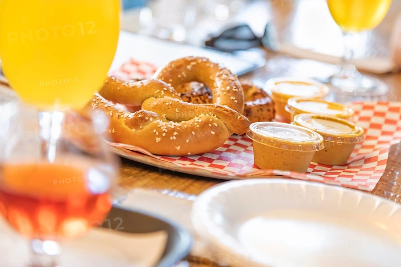 Abstract of small glass of micro brew beers and warm pretzels on bar