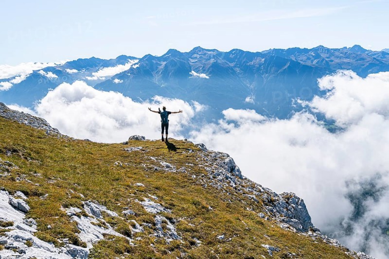 Hiker above the clouds