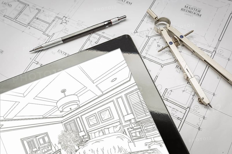 Computer tablet showing room illustration sitting on house plans with pencil and compass