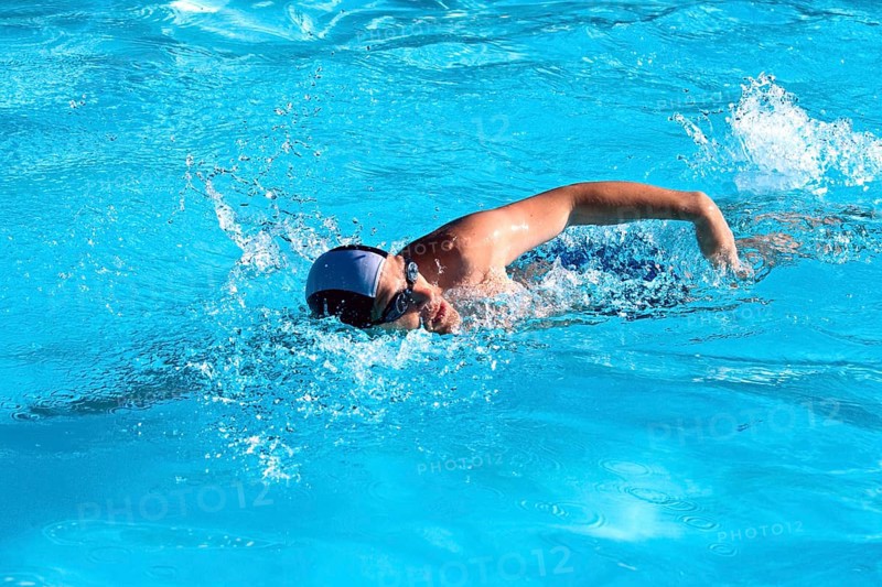 Athletic Man swimming in the pool