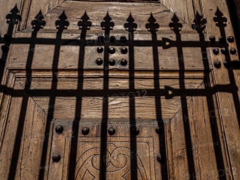 Shadow from a fence at the church gate