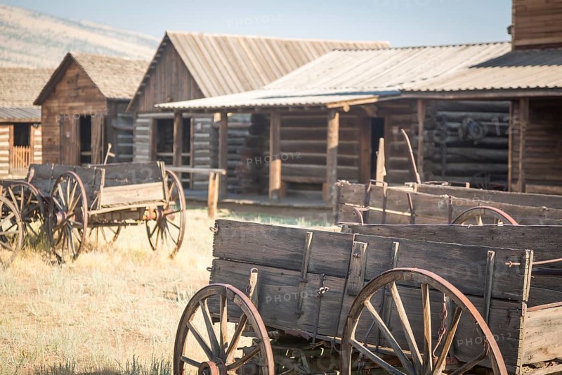 Abstract of vintage antique wood wagon and log cabins