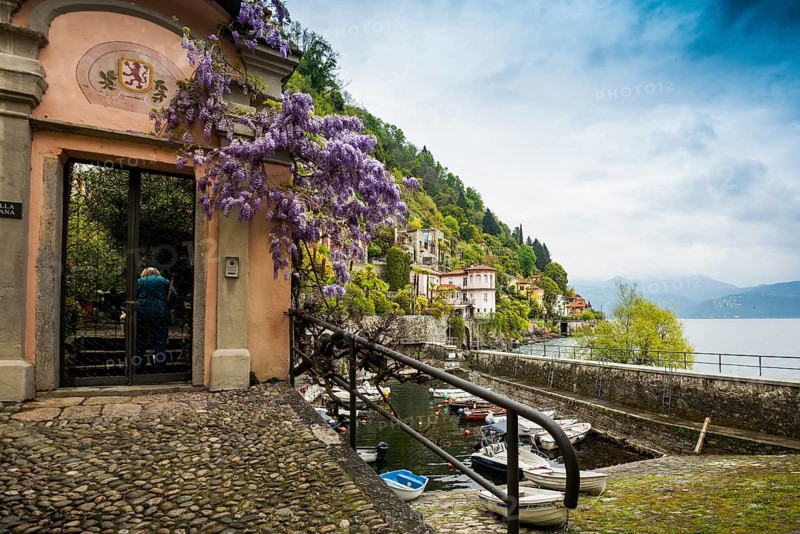Small boat harbour and colourful villas on the lakeside