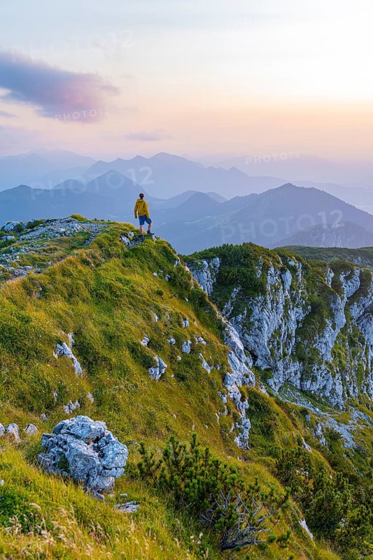 Hikers at the summit of the Benediktenwand at sunset