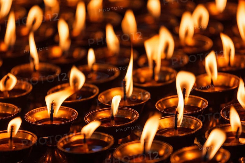 Burning candles in Buddhist temple. Dharamsala