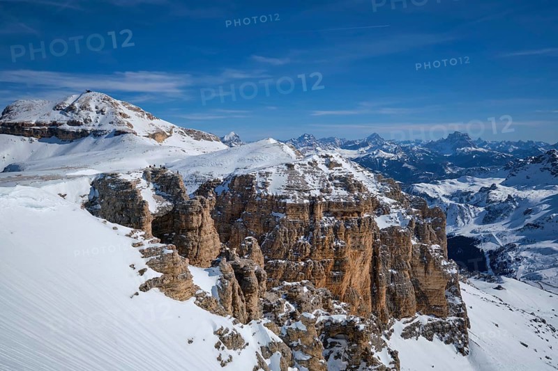 View of a ski resort piste and Dolomites mountains in Italy from Passo Pordoi pass. Arabba