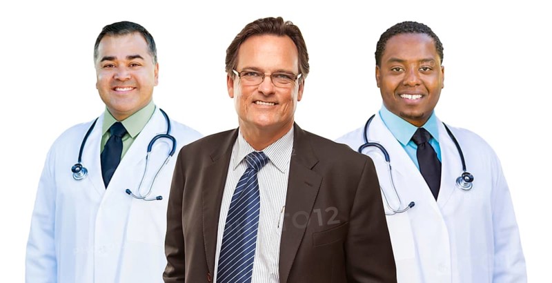Two mixed-race doctors behind businessman isolated on a white background