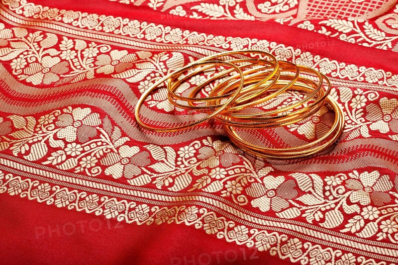 Indian sari with golden bangles clouse up