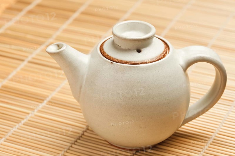 Chinese teapot on bamboo mat close up photo