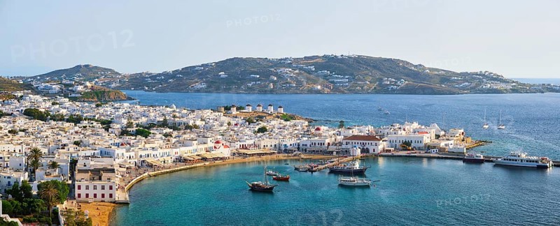 View of Mykonos town Greek tourist holiday vacation destination with famous windmills