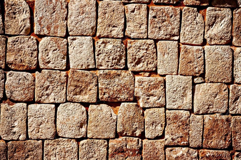 Texture of stone wall of ancient Mayan pyramids in Uxmal