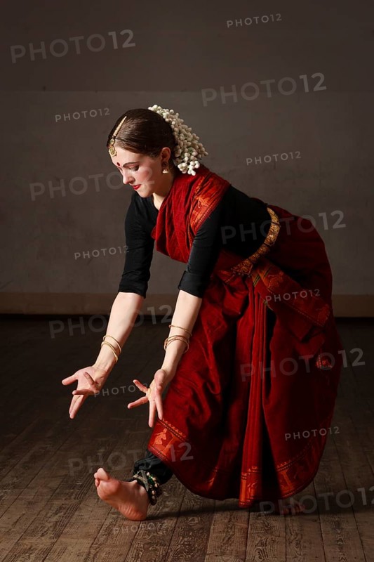 Young woman in sary dancing classical traditional indian dance Bharat Natyam