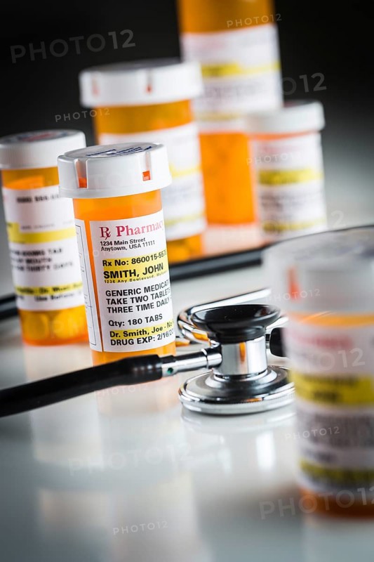 Several non-proprietary medicine prescription bottles abstract with stethoscope