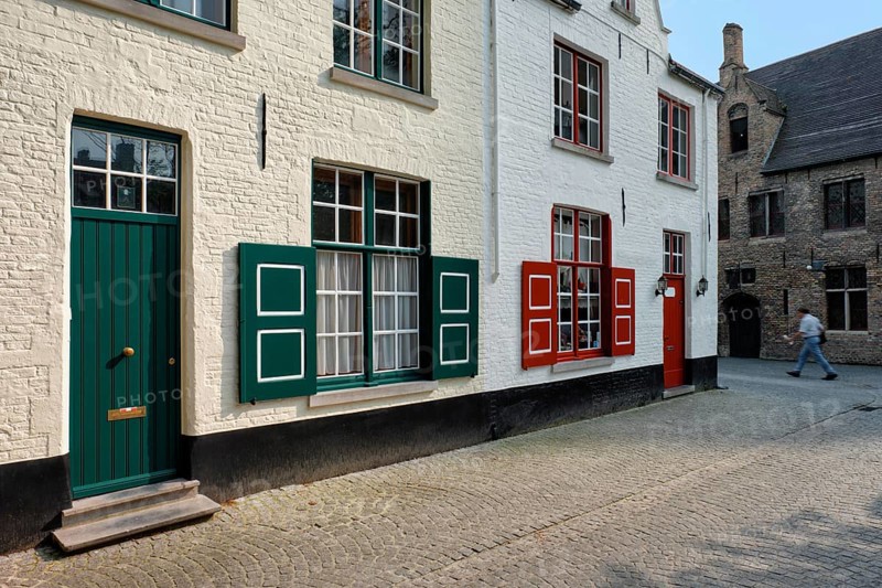 Door and window of an old house and street with motion blurred man