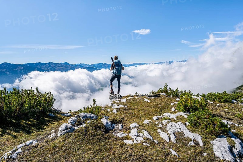 Hiker above the clouds