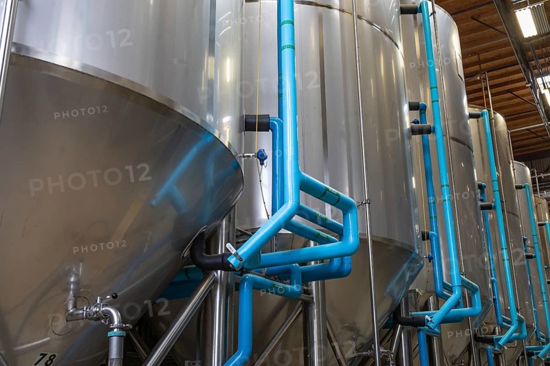 Large beer brewery fermentation tanks in warehouse