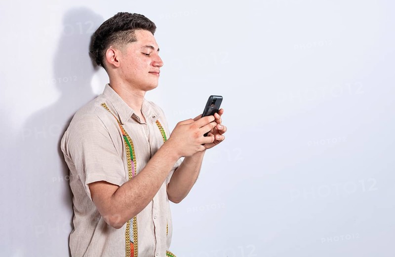 Handsome guy happy with his cell phone on isolated backgrounds