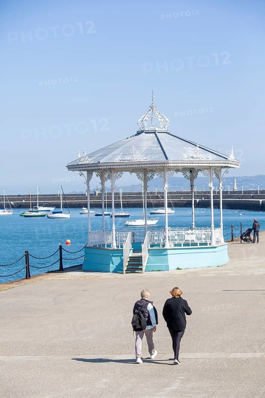 Promenade with passers-by and pavilion at Dun Laoghaire on a nice day. County Dublin