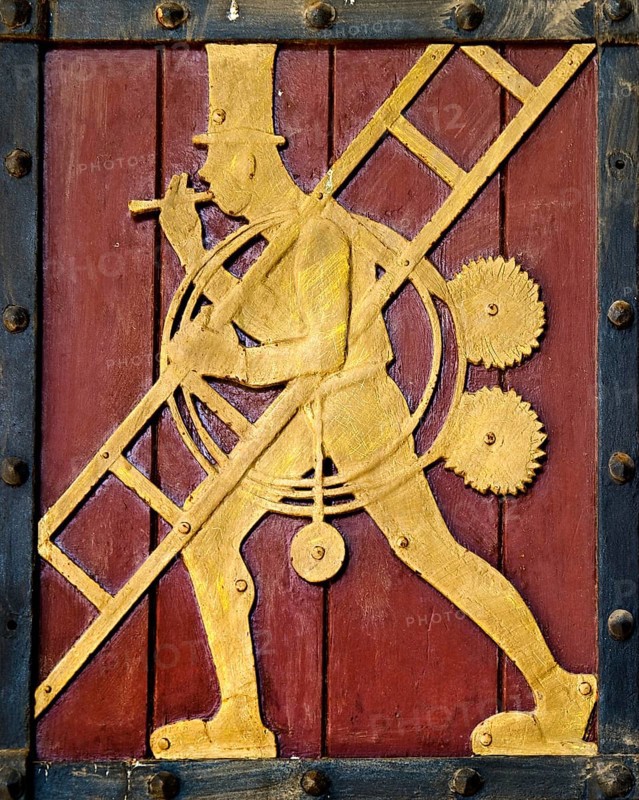 Historic figure on the door to the Ratskeller representing the craft of the chimney sweep