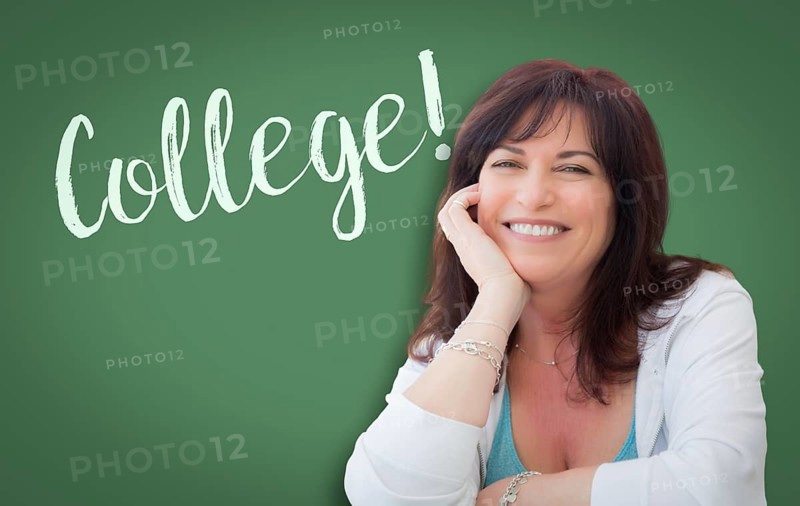 College written on green chalkboard behind smiling middle aged woman