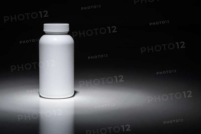 Blank white bottle ready for your text under spot light