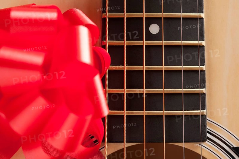Guitar strings with red ribbon