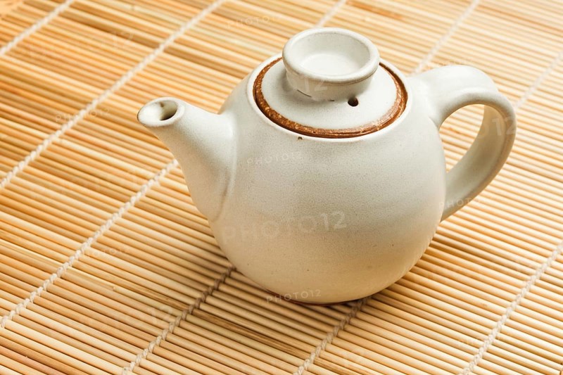 Chinese teapot on bamboo mat close up photo