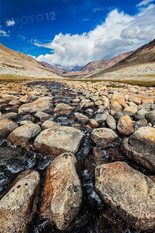Mountain stream with stones in Himalayas near Khardung La pass. Ladakh
