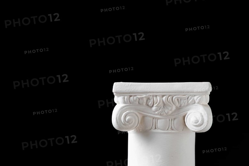 White ionic design column on dark background