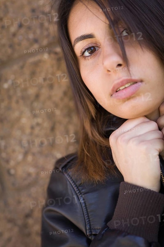 Beautiful meloncholy mixed-race young woman portrait outside