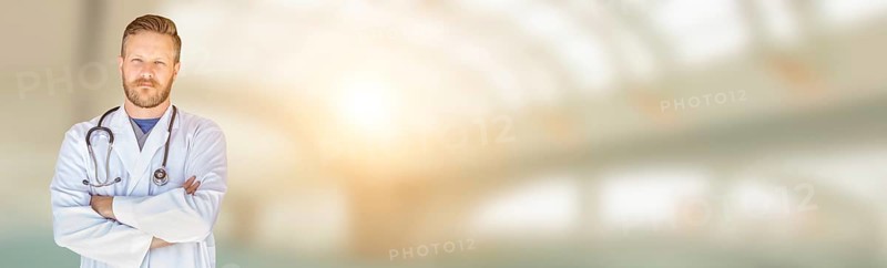 Banner of handsome young adult male doctor with beard inside hospital building