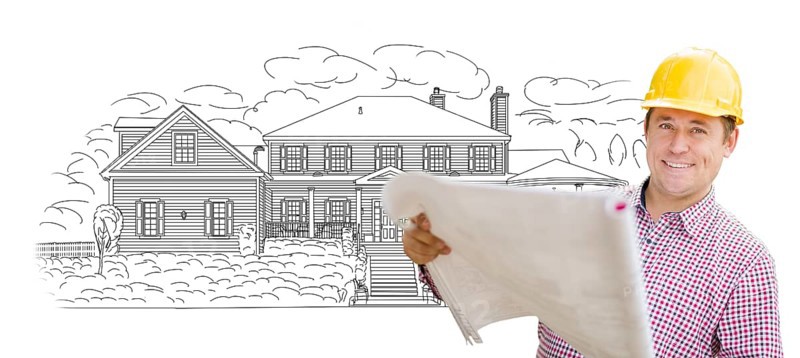Smiling contractor holding blueprints over custom home drawing