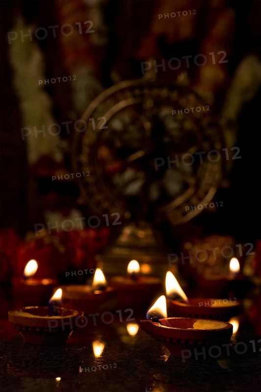 Diwali lights oil candles with Shiva Nataraja in the background for Maha Shivaratri